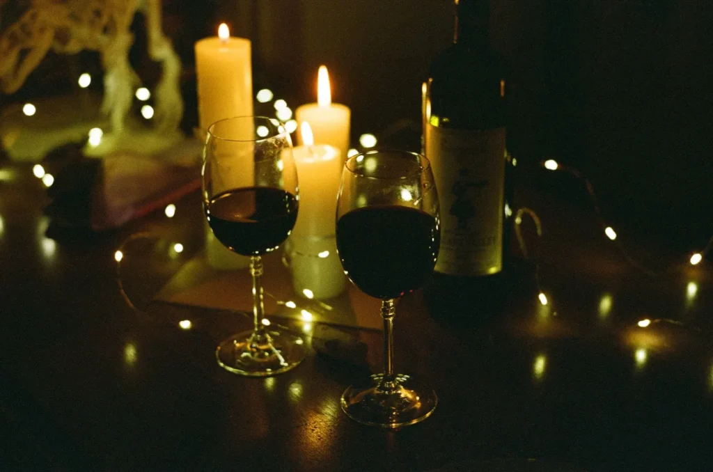 Wine glasses and a bottle in candlelight
